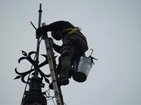 Repairing the weather vane on St James Church