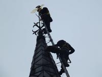 Repairing the weather vane on St James Church